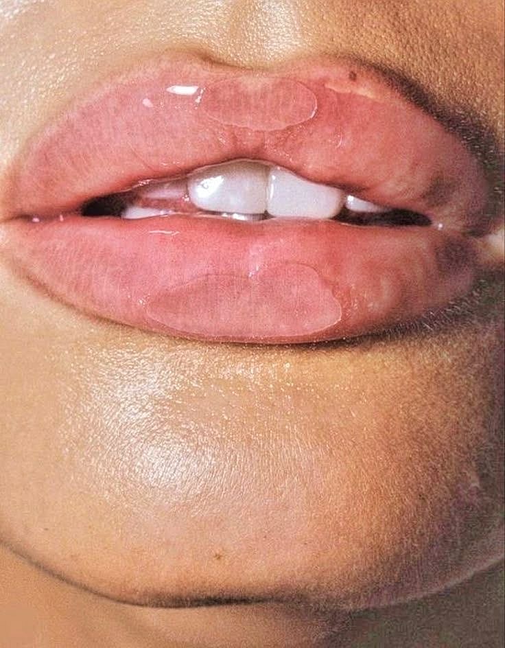 Woman with long hair smiling softly at camera.