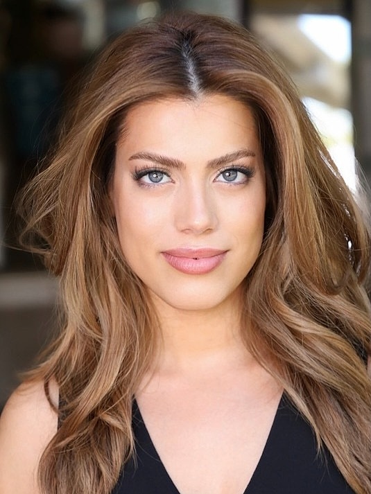 Woman with long hair and bright blue eyes.