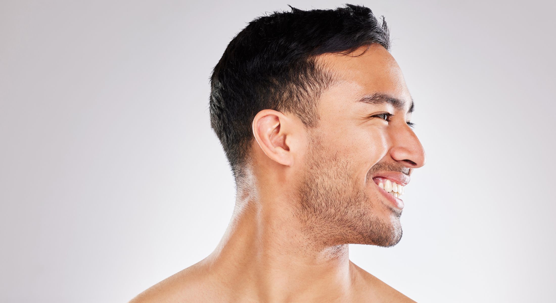 Smiling man against a light background.